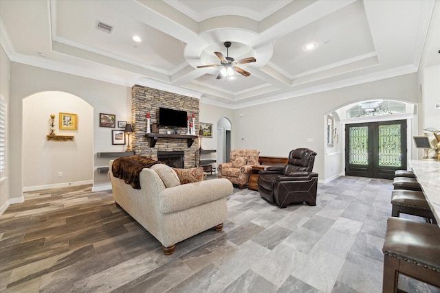 living room featuring ceiling fan, french doors, a fireplace, and ornamental molding