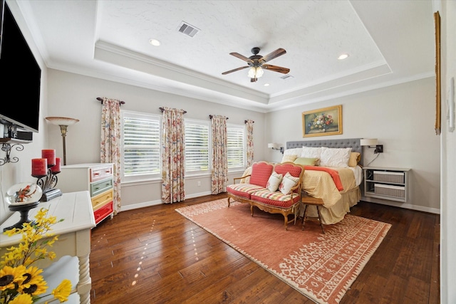 bedroom with ceiling fan, dark hardwood / wood-style flooring, crown molding, and a raised ceiling