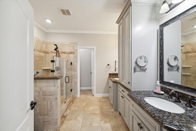 bathroom featuring crown molding, a shower with shower door, and vanity