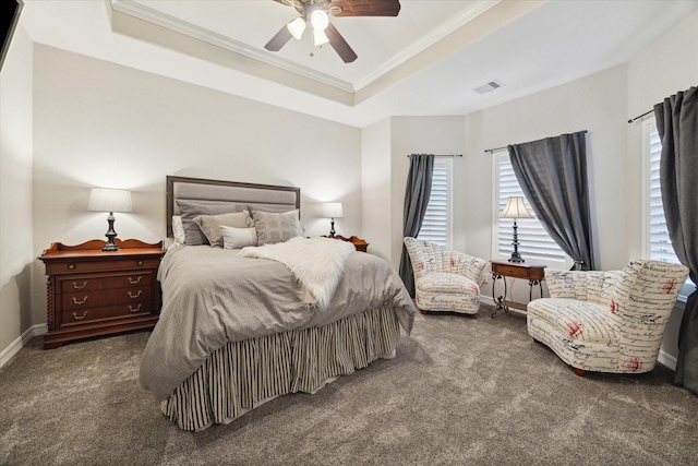 bedroom featuring ceiling fan, a raised ceiling, and dark colored carpet