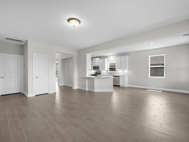 unfurnished living room with hardwood / wood-style flooring