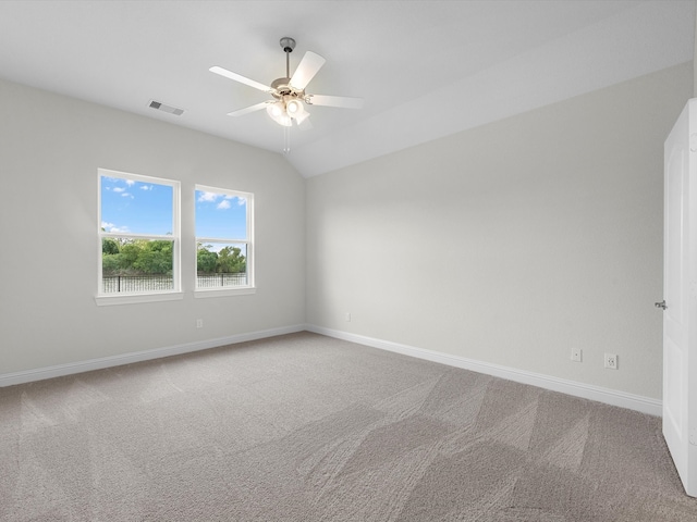 spare room featuring carpet flooring, ceiling fan, and lofted ceiling