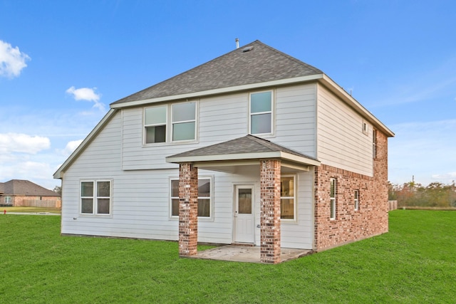 rear view of house with a patio area and a yard