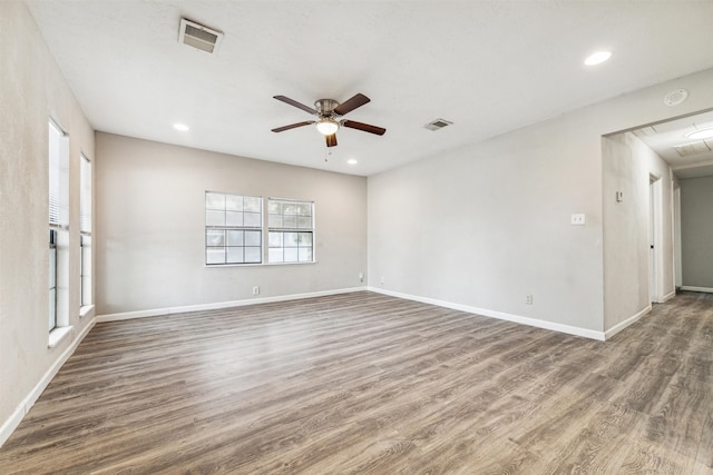 empty room featuring dark hardwood / wood-style flooring and ceiling fan