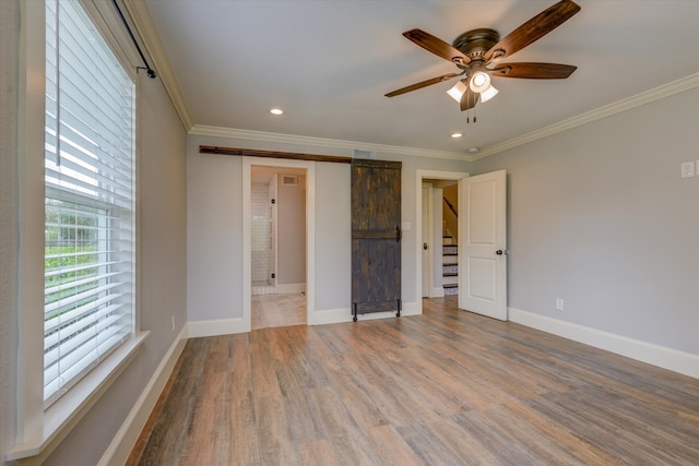 unfurnished bedroom featuring ornamental molding, wood-type flooring, a closet, and ceiling fan