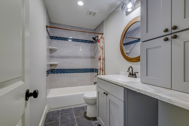 full bathroom with shower / tub combo, tile patterned flooring, vanity, and toilet