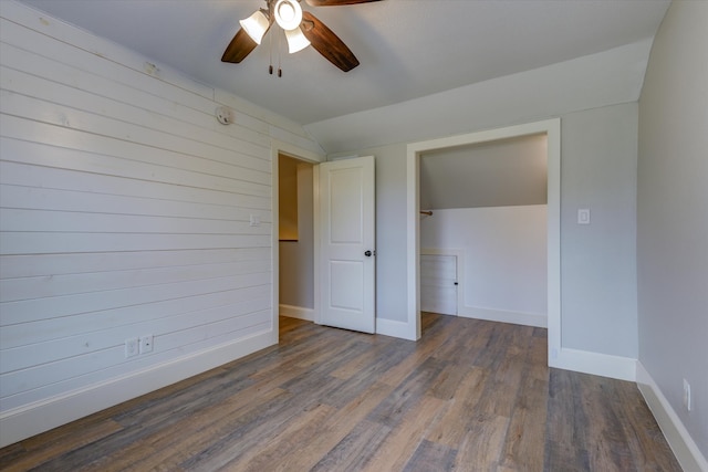 unfurnished bedroom with a closet, lofted ceiling, ceiling fan, and dark hardwood / wood-style floors