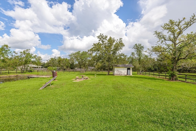 view of yard featuring a storage unit and a rural view