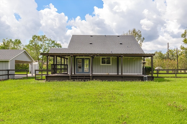 back of house featuring an outbuilding and a yard