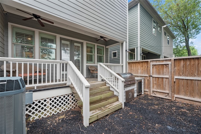 entrance to property featuring cooling unit and ceiling fan