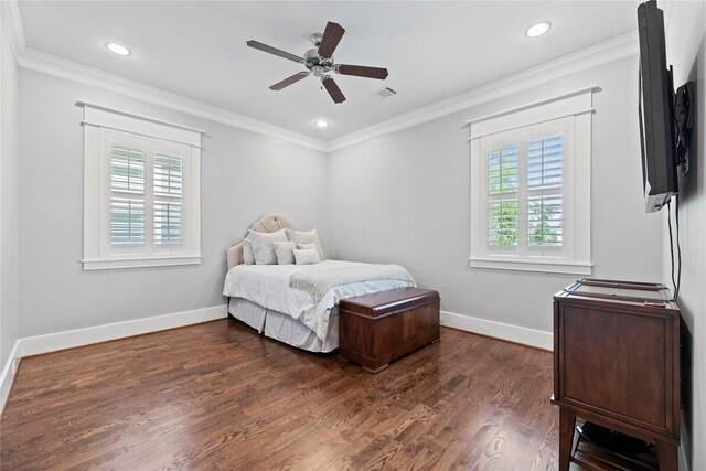 bedroom featuring dark wood-type flooring, crown molding, multiple windows, and ceiling fan