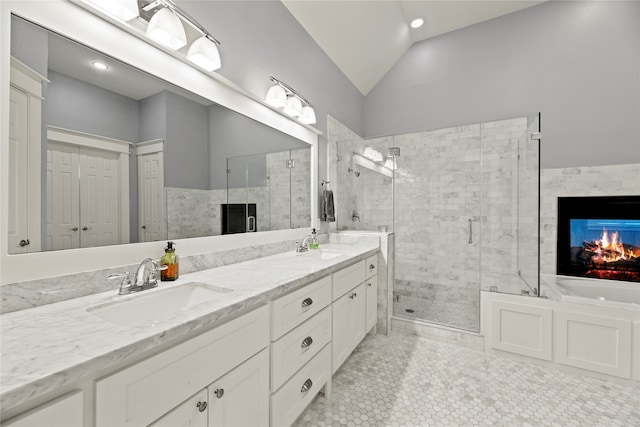 bathroom with lofted ceiling, tile patterned flooring, separate shower and tub, and vanity