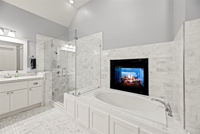 bathroom with lofted ceiling, tile patterned floors, separate shower and tub, and vanity