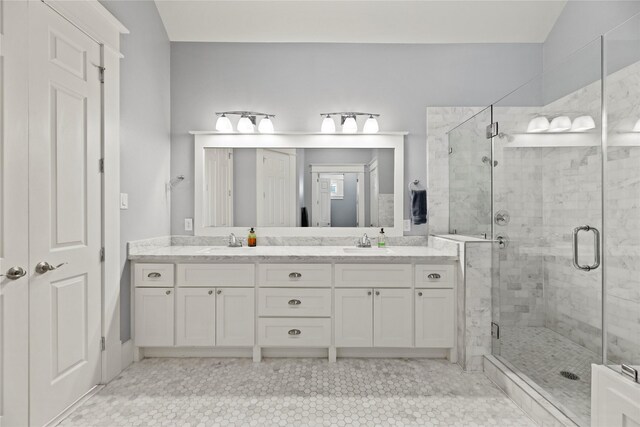 bathroom with tile patterned floors, an enclosed shower, vaulted ceiling, and vanity