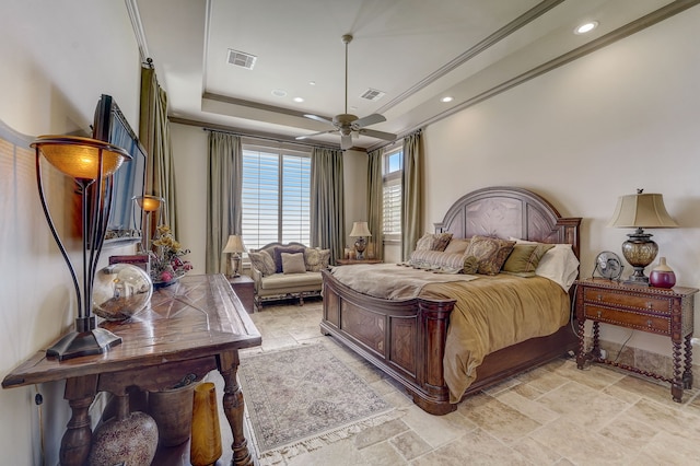 bedroom with a raised ceiling, crown molding, and ceiling fan