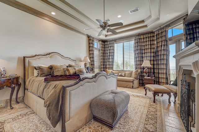 bedroom with crown molding, ceiling fan, and a raised ceiling