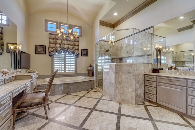 bathroom featuring independent shower and bath, vanity, a chandelier, and a healthy amount of sunlight