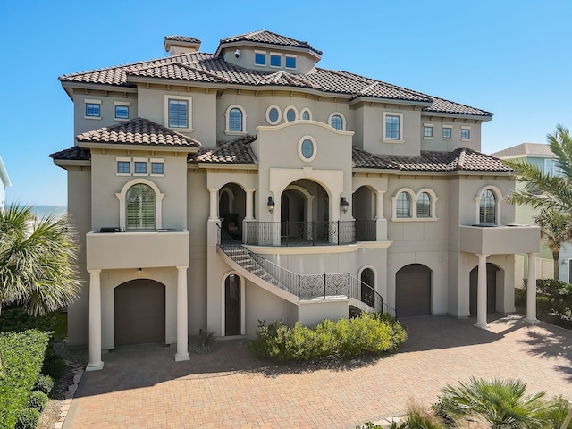 mediterranean / spanish-style house with a balcony and a garage