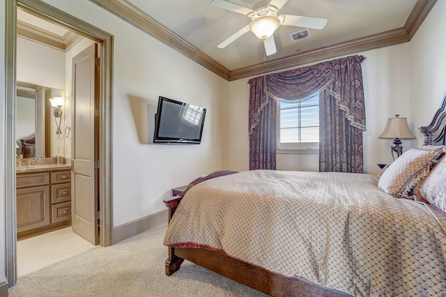 carpeted bedroom with ceiling fan, ensuite bathroom, and crown molding