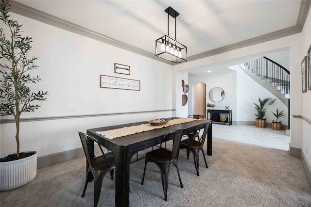 dining room with carpet floors and ornamental molding