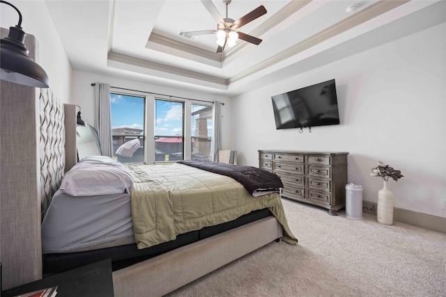 carpeted bedroom with a raised ceiling, crown molding, and ceiling fan