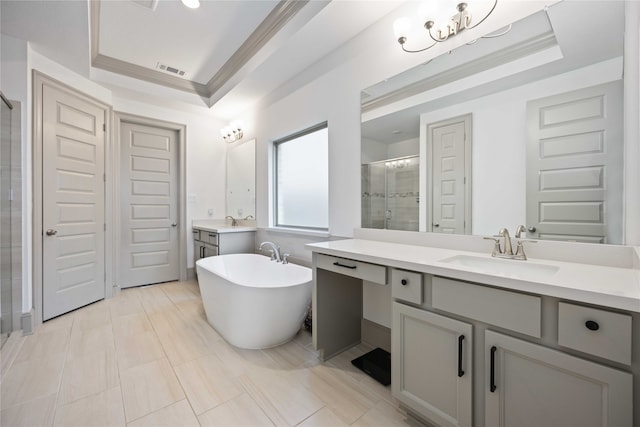 bathroom with a tray ceiling, tile patterned flooring, vanity, and shower with separate bathtub