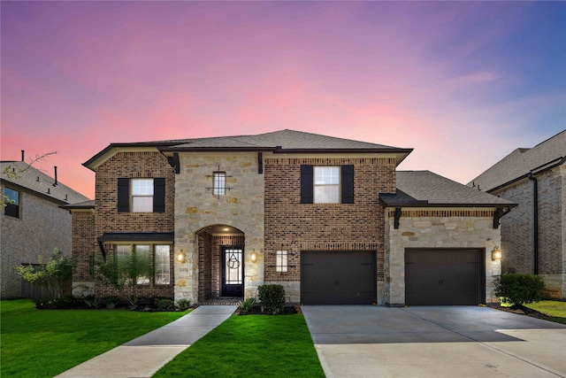 view of front facade featuring a garage and a lawn