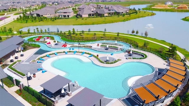 view of pool featuring a patio, a water view, and a hot tub