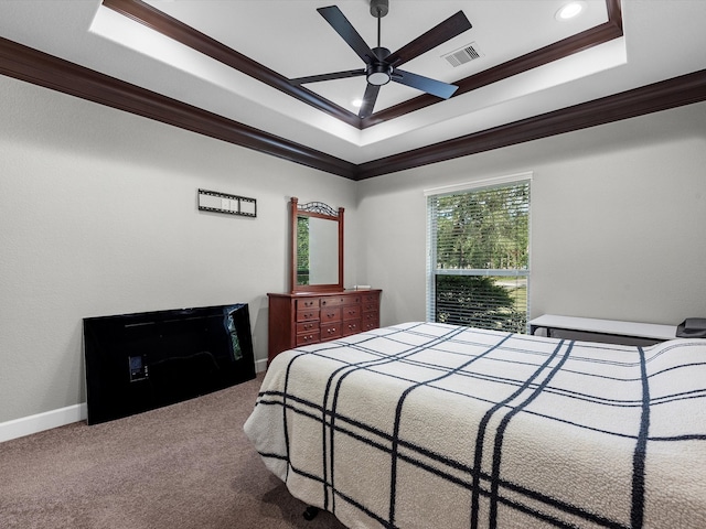 bedroom with ornamental molding, ceiling fan, a raised ceiling, and carpet flooring