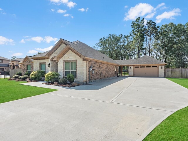 ranch-style house featuring a garage and a front lawn