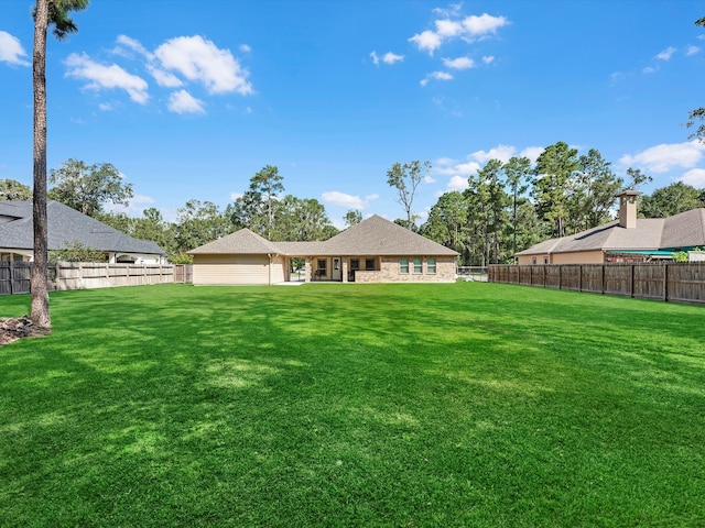 back of property featuring a yard