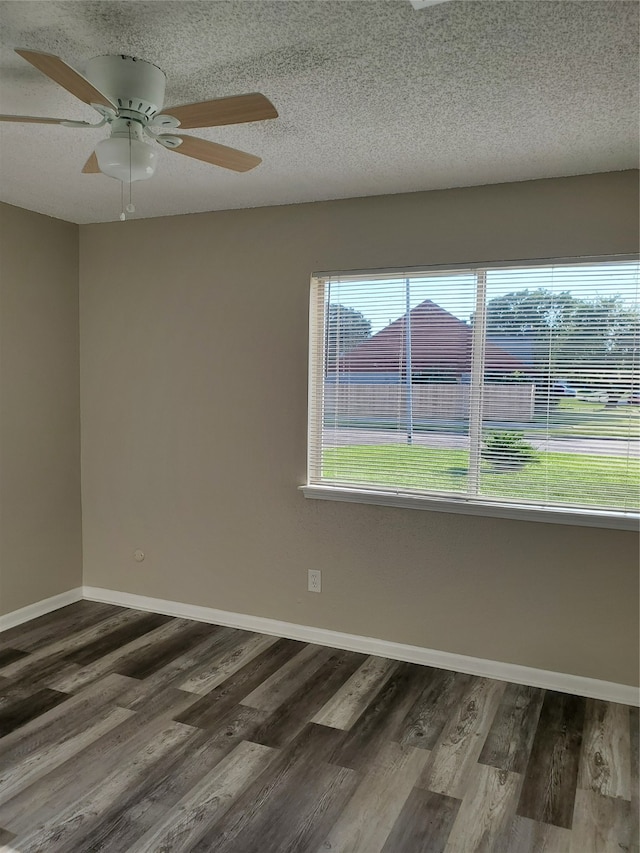 unfurnished room with a textured ceiling, dark hardwood / wood-style flooring, and ceiling fan