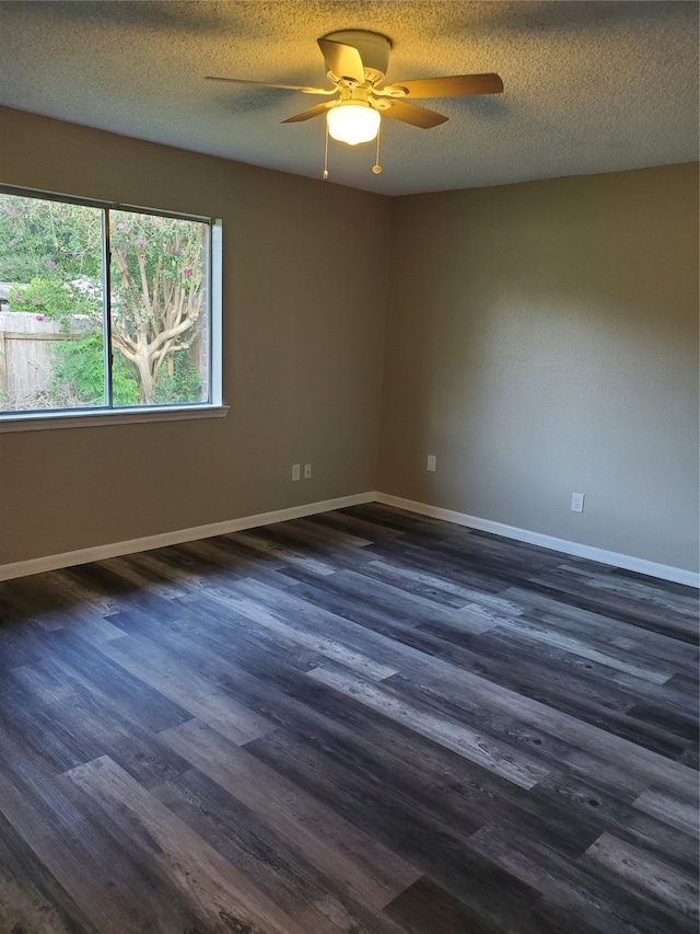 empty room with a textured ceiling, dark hardwood / wood-style flooring, and ceiling fan