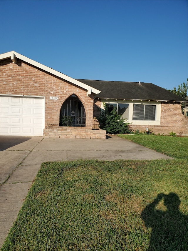 single story home with a front lawn and a garage