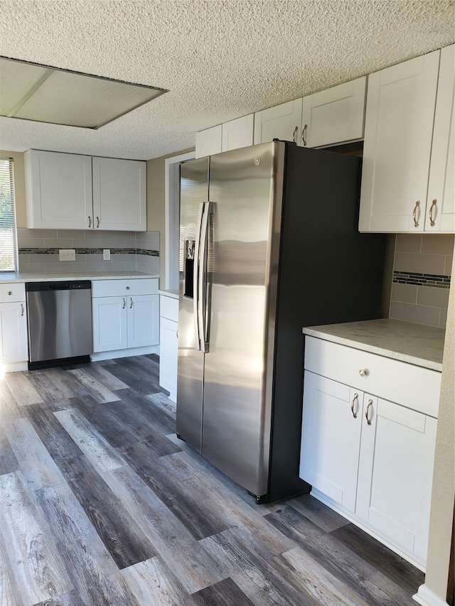 kitchen featuring white cabinets, appliances with stainless steel finishes, and dark hardwood / wood-style flooring