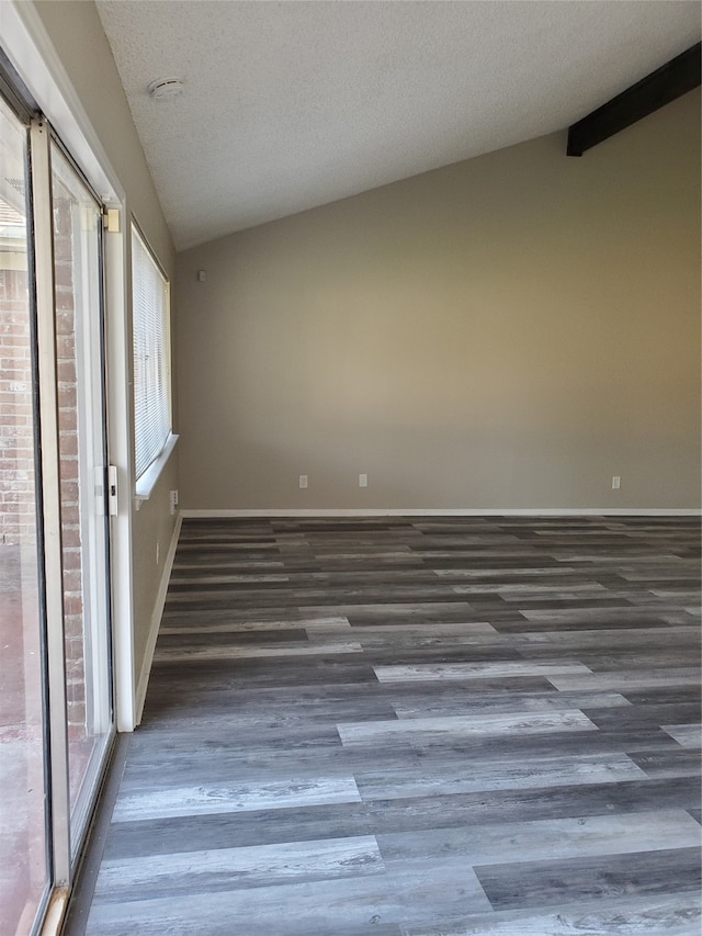 unfurnished room featuring a textured ceiling, vaulted ceiling, and dark wood-type flooring