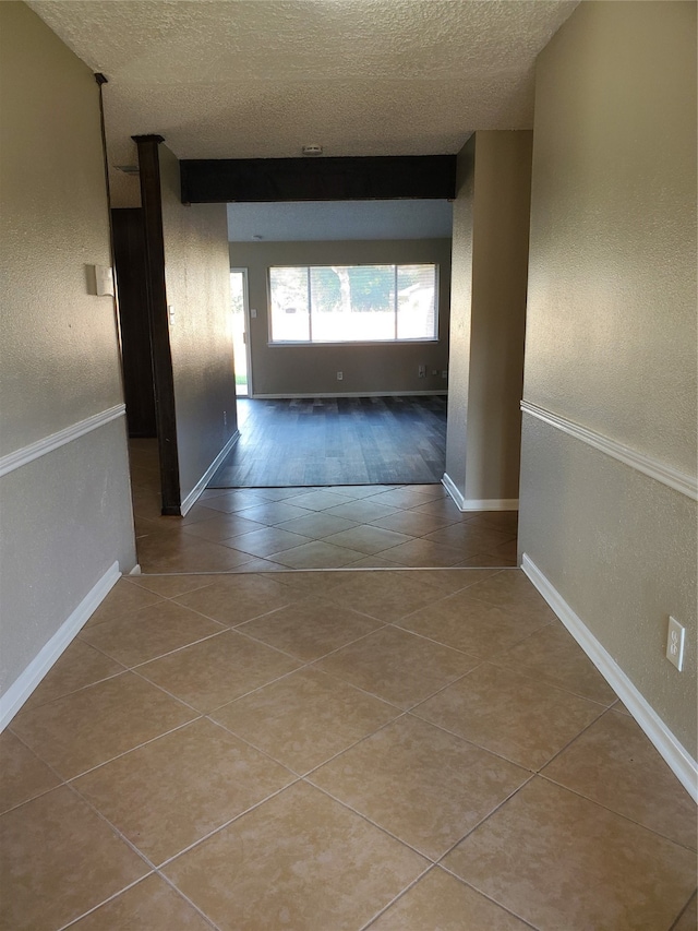 hallway featuring a textured ceiling and hardwood / wood-style floors