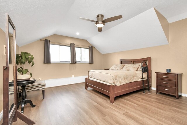 5522 Cannonway Dr, Houston, TX 77032 - bedroom with baseboards, ceiling fan, vaulted ceiling, and light wood-style flooring