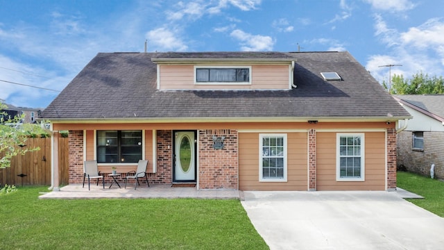 view of front of house featuring a front lawn and a patio