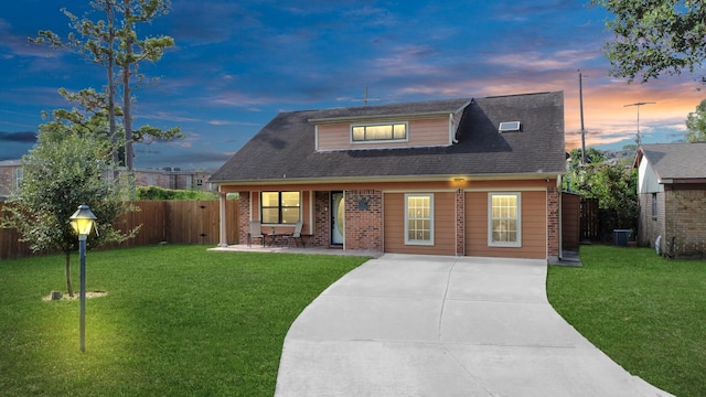 view of front of house with a lawn and central AC unit