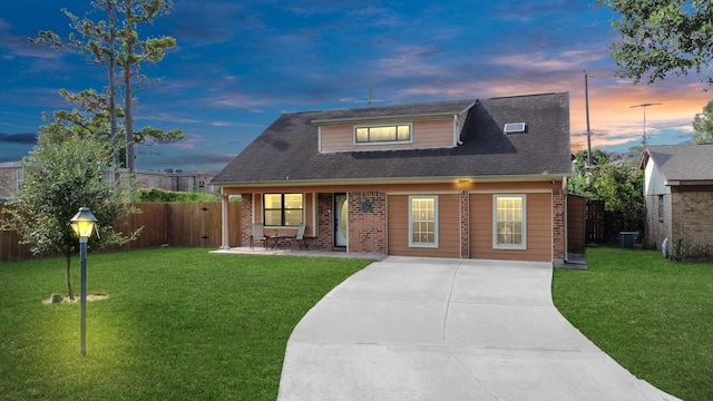5522 Cannonway Dr, Houston, TX 77032 - view of front of house with a patio, a front lawn, central air condition unit, and fence
