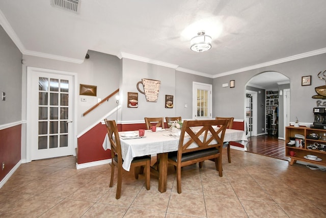 5522 Cannonway Dr, Houston, TX 77032 - dining room featuring arched walkways, visible vents, ornamental molding, and light tile patterned floors