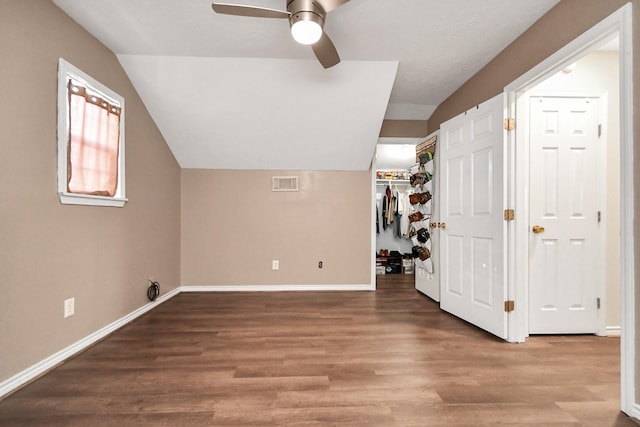 bonus room featuring ceiling fan, hardwood / wood-style flooring, and lofted ceiling