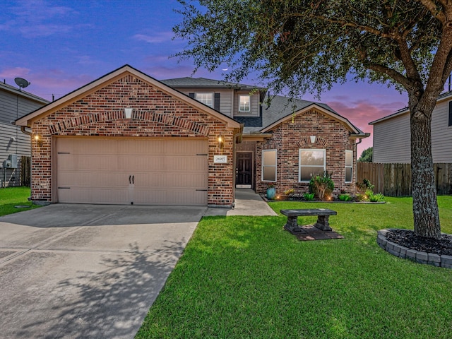 view of front property with a garage and a yard