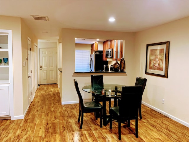 dining area featuring light wood-type flooring