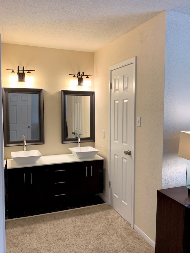 bathroom with a textured ceiling and vanity