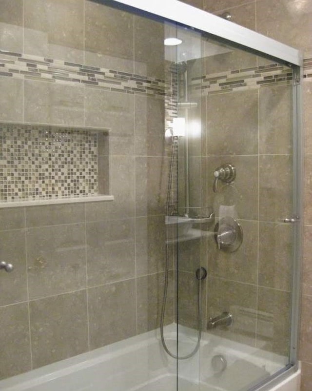 bathroom featuring shower / bath combination with glass door