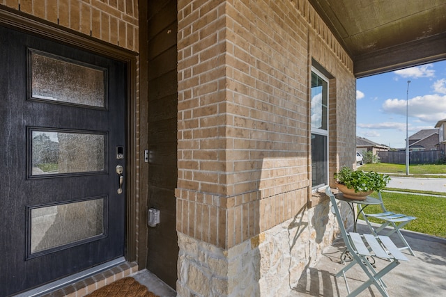 view of exterior entry with covered porch