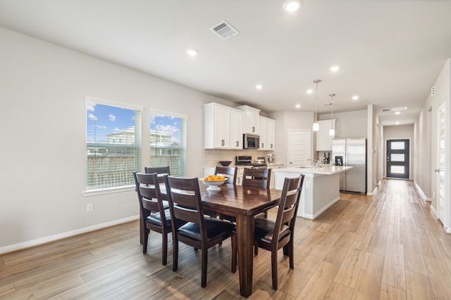 dining area featuring light hardwood / wood-style flooring and sink