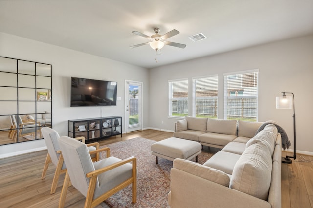 living room with ceiling fan and wood-type flooring